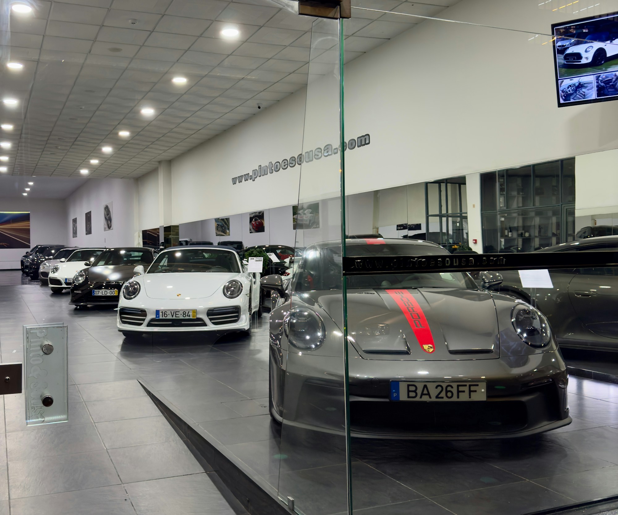 Real luxury car showroom with vehicles on a polished floor