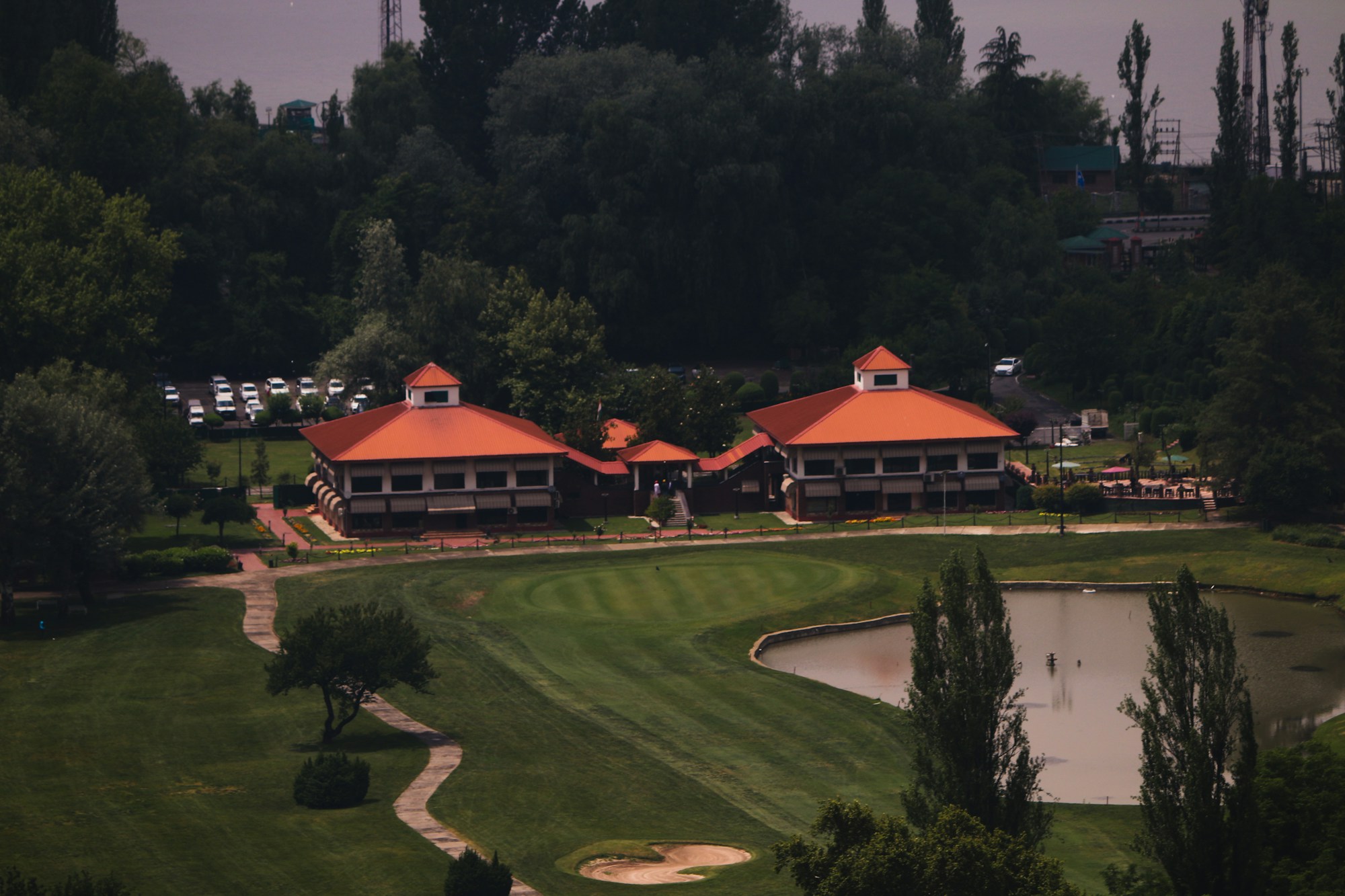 Real golf clubhouse buildings overlooking a course and pond